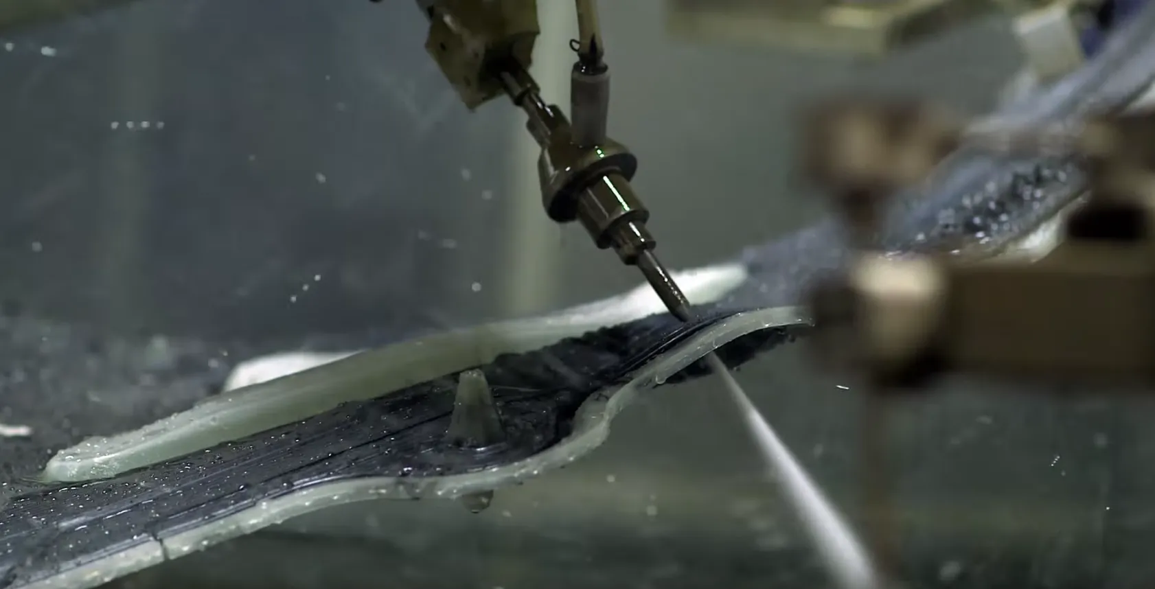 Five-axis waterjet cutting openings in carbon-fiber structure
