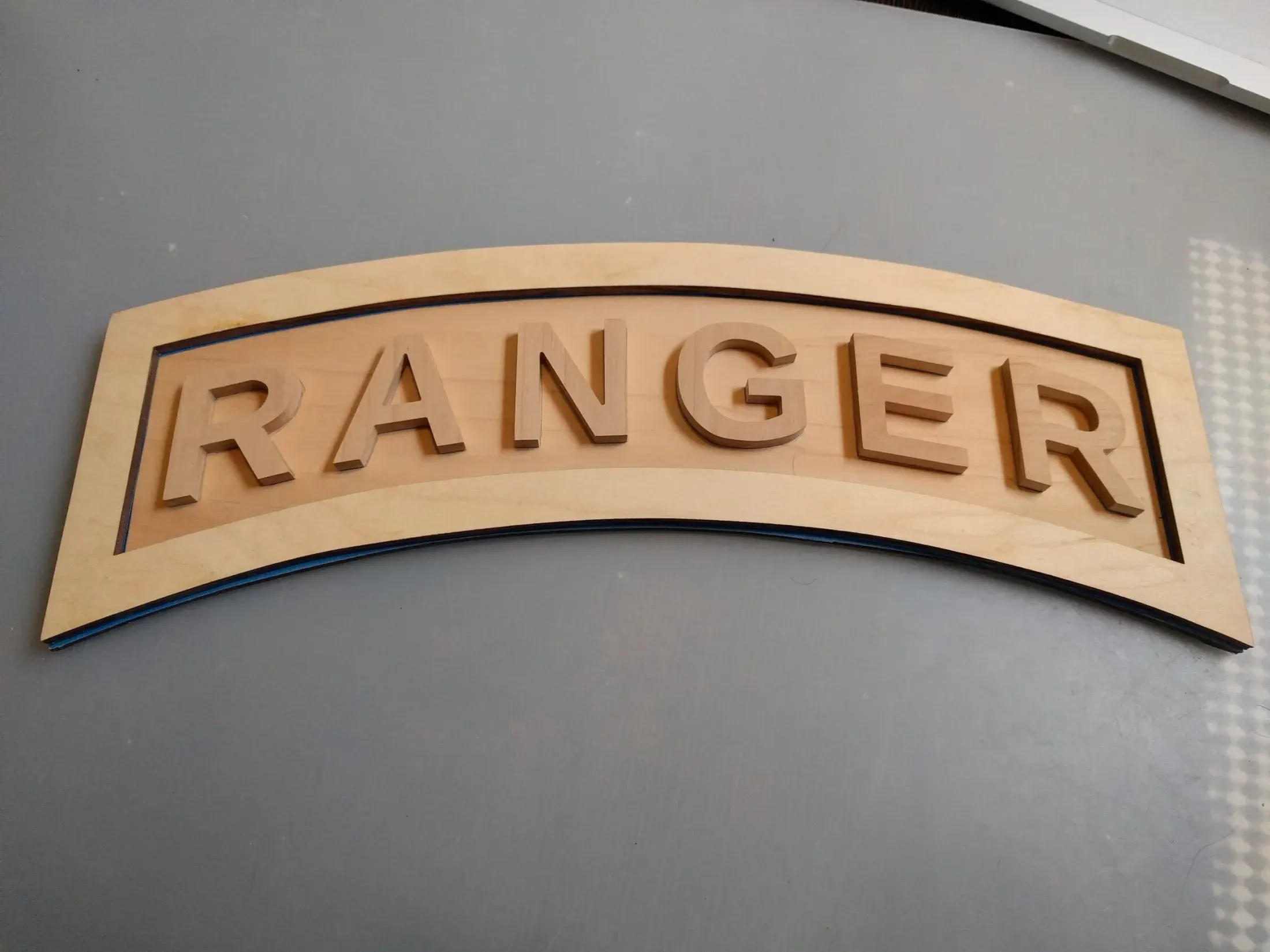 Dry layout of letters, backing plate, and outer outline