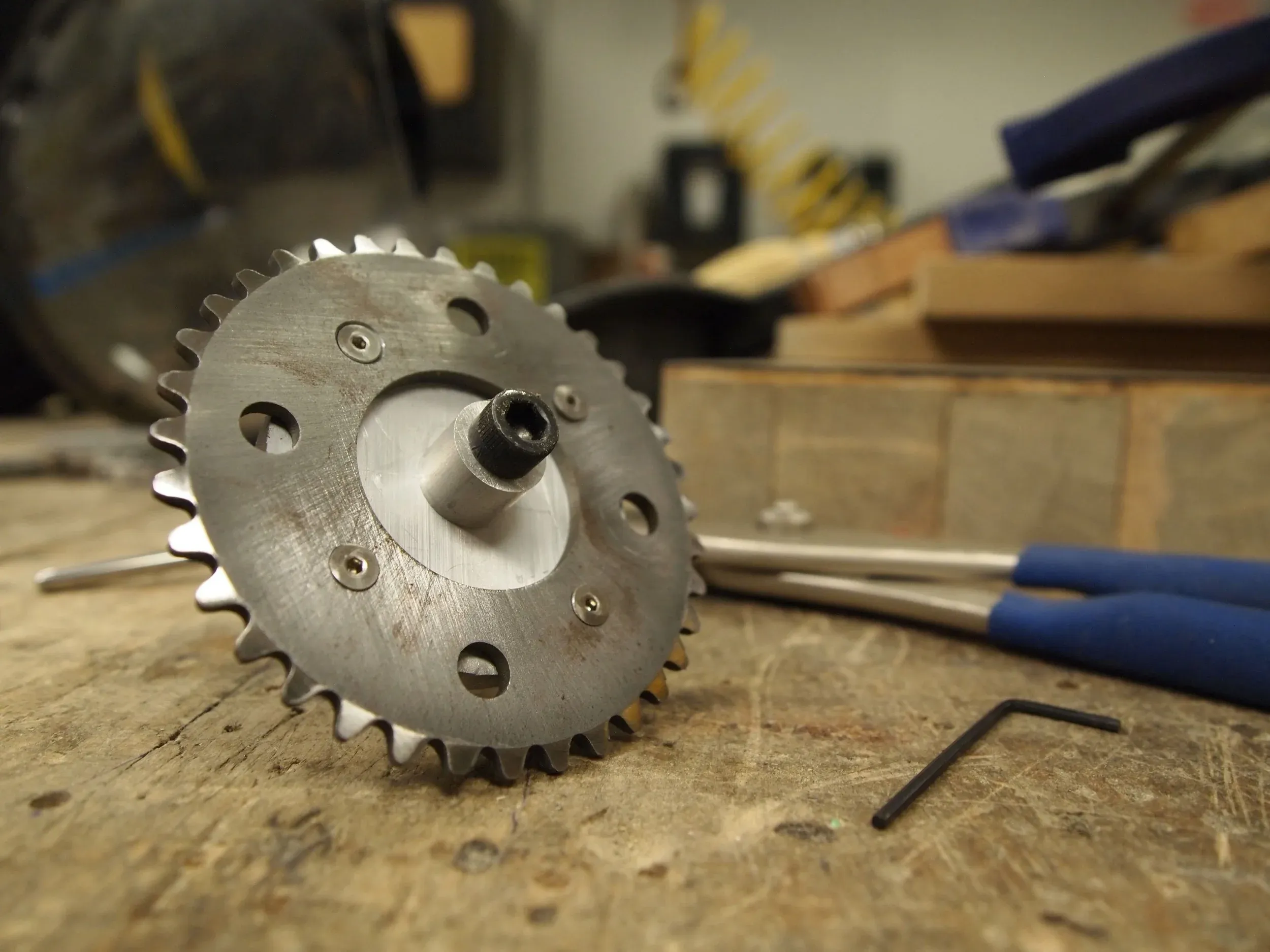 The finished sprocket attached to the arbor I used to hold it in the drill.