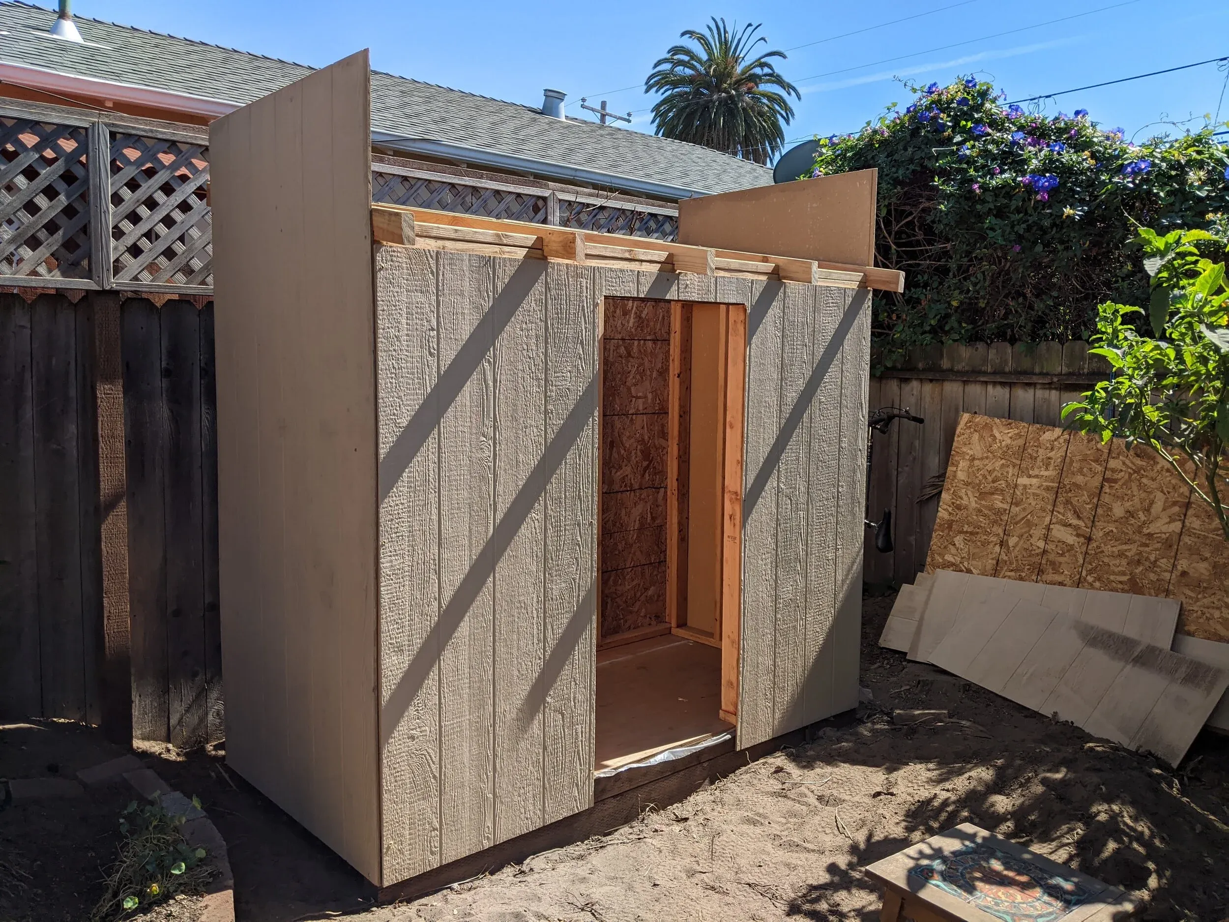 Once the roof rafters were installed, we could begin work on the siding. Attaching two uncut 4 x 8 sheets on the sides ended up working well, since they assisted in guiding the roof plywood into place.