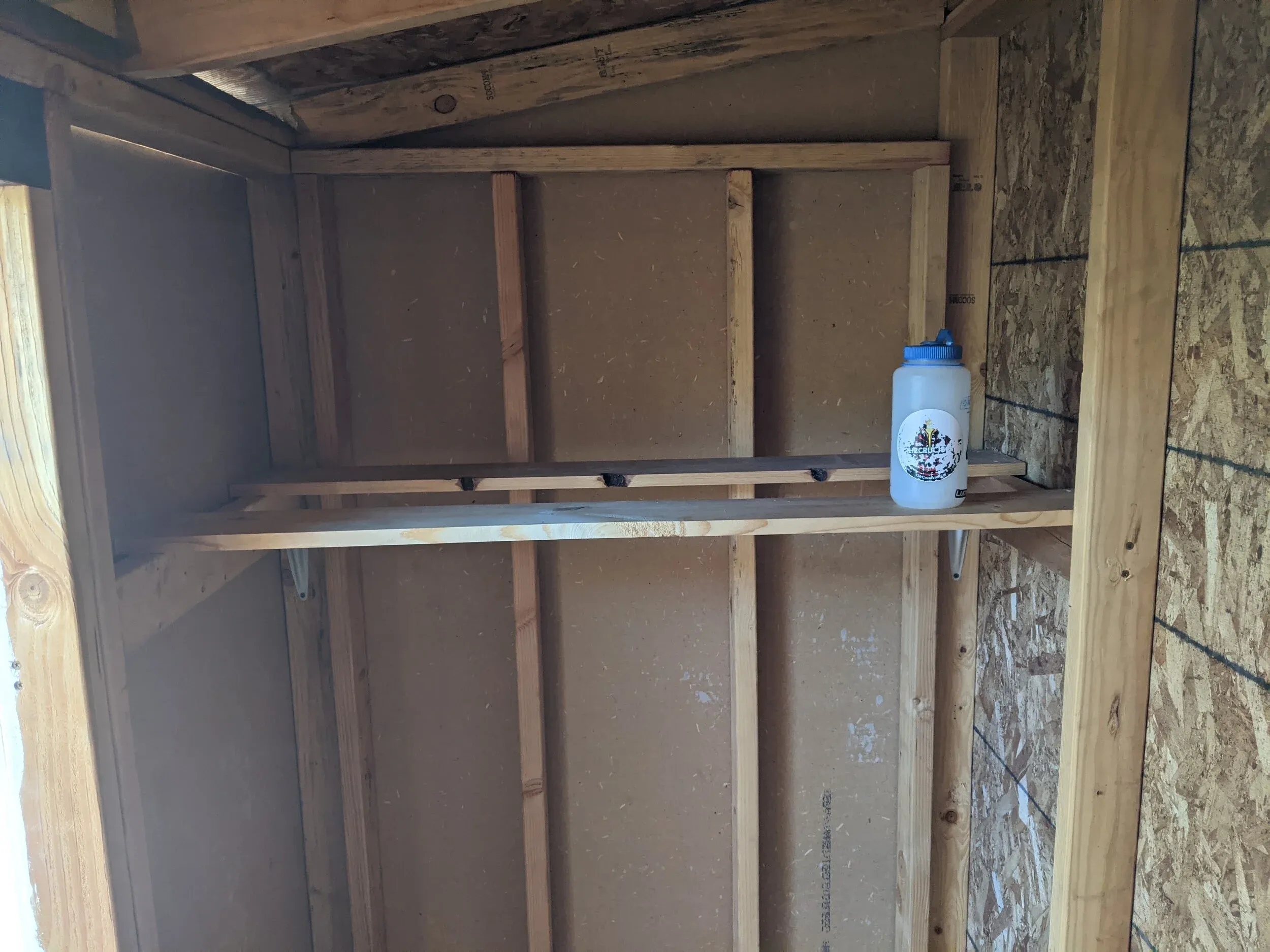 Once the outside was complete and painted, I moved onto the inside, where I added shelves and hooks for storage.